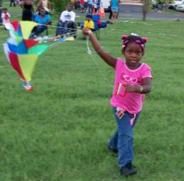 Dijamore Felix, 3, tries to get her kite airborne. Dijamore Felix, 3, tries to get her kite airborne.
